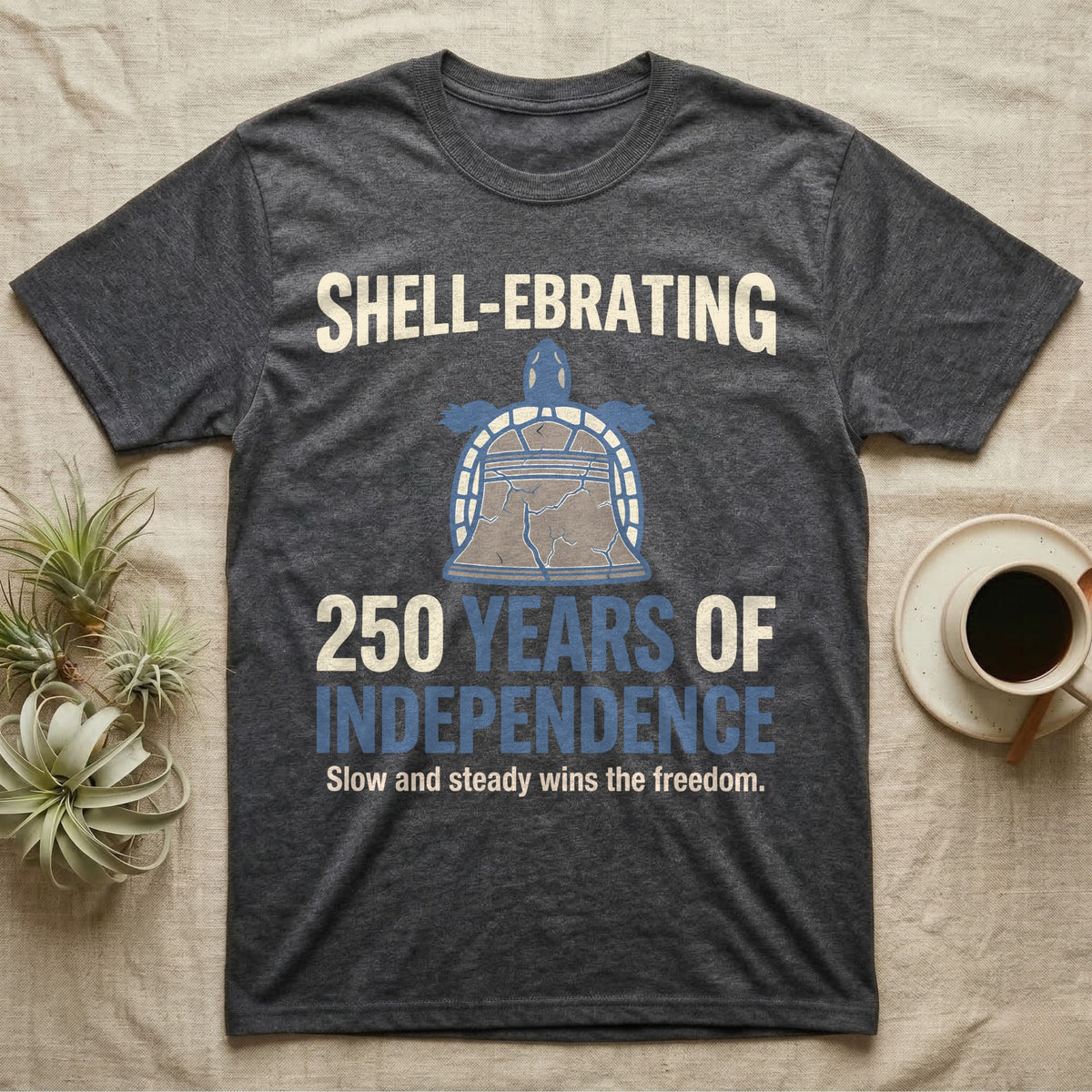 Sea Turtle Liberty Bell T-Shirt in Dark Heather — Slate-blue and cream tee of a sea turtle whose shell is drawn as the Liberty Bell under Shell-Ebrating 250 Years text.