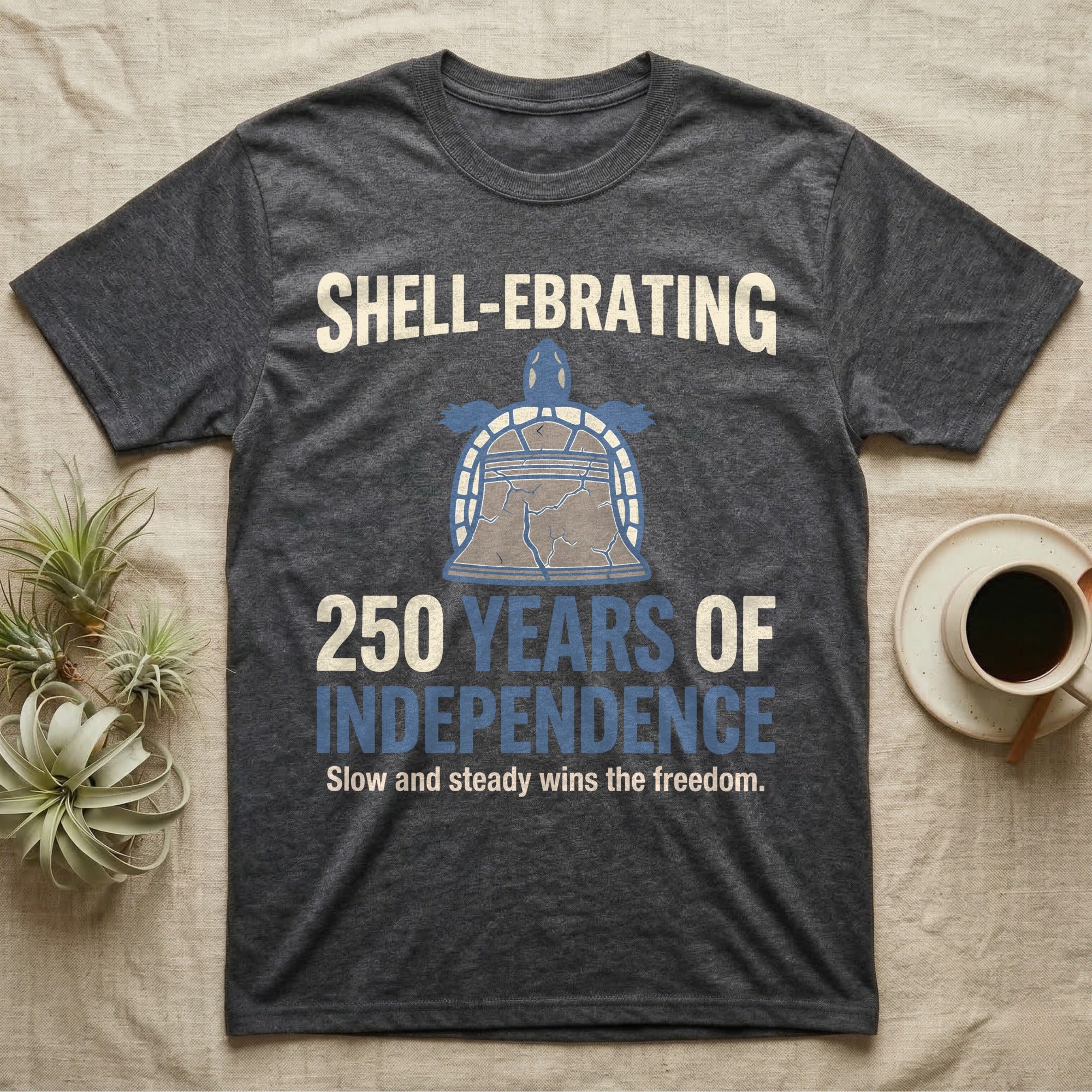 Sea Turtle Liberty Bell T-Shirt in Dark Heather — Slate-blue and cream tee of a sea turtle whose shell is drawn as the Liberty Bell under Shell-Ebrating 250 Years text.