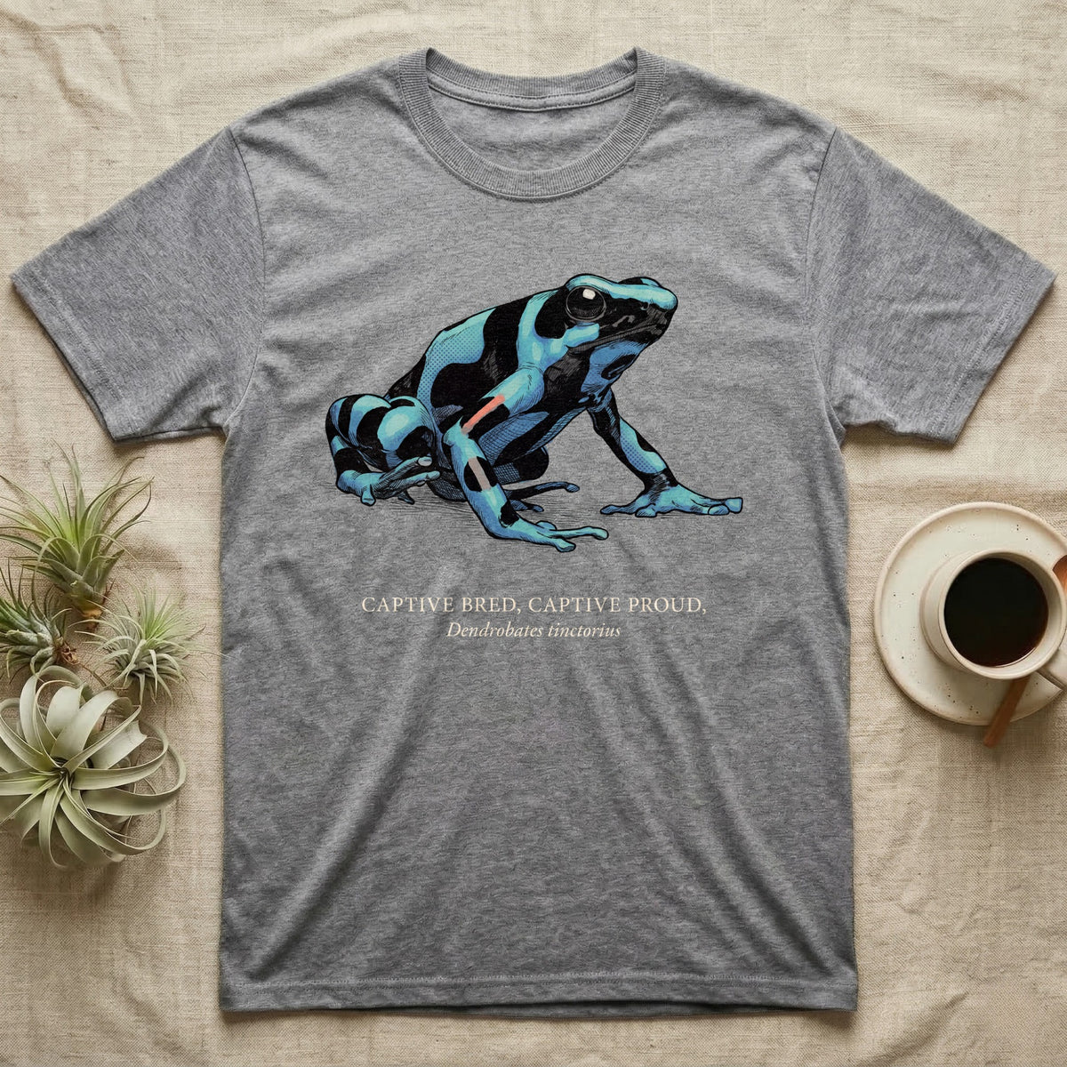 Captive Bred Frog T-Shirt in Sport Grey — Naturalist-plate illustration of a healthy dyeing dart frog above a serif creed reading Captive Bred Captive Proud.
