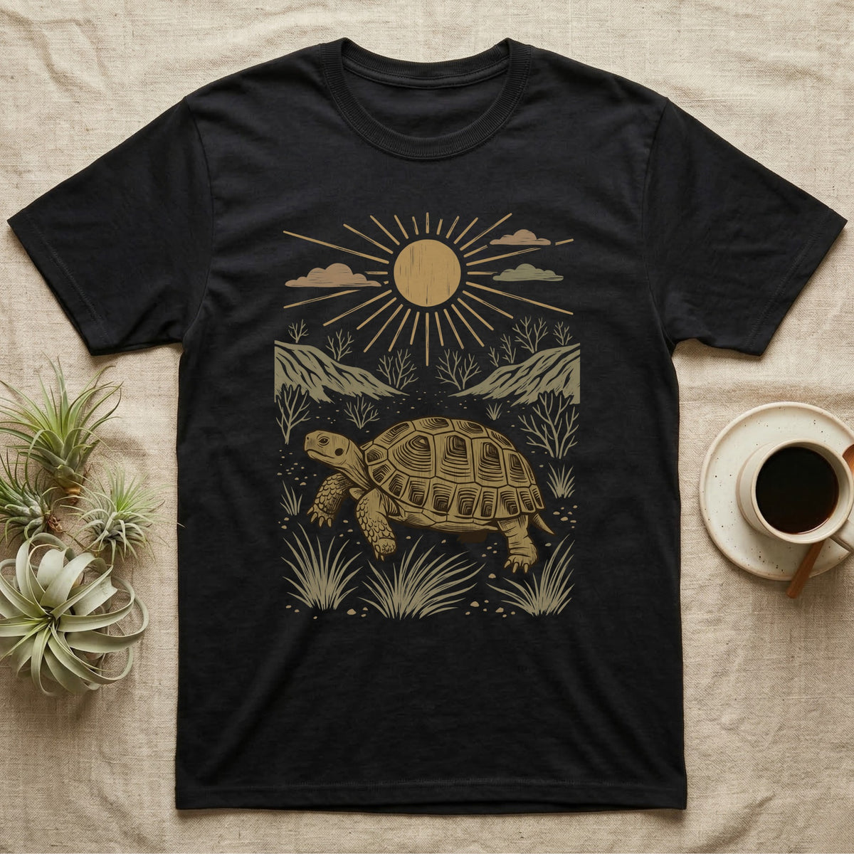 Russian Tortoise Home Range T-Shirt in Black — Woodcut-style illustration of a Russian tortoise walking across gravelly steppe under a full sun with dry hills behind, no on-shirt text.