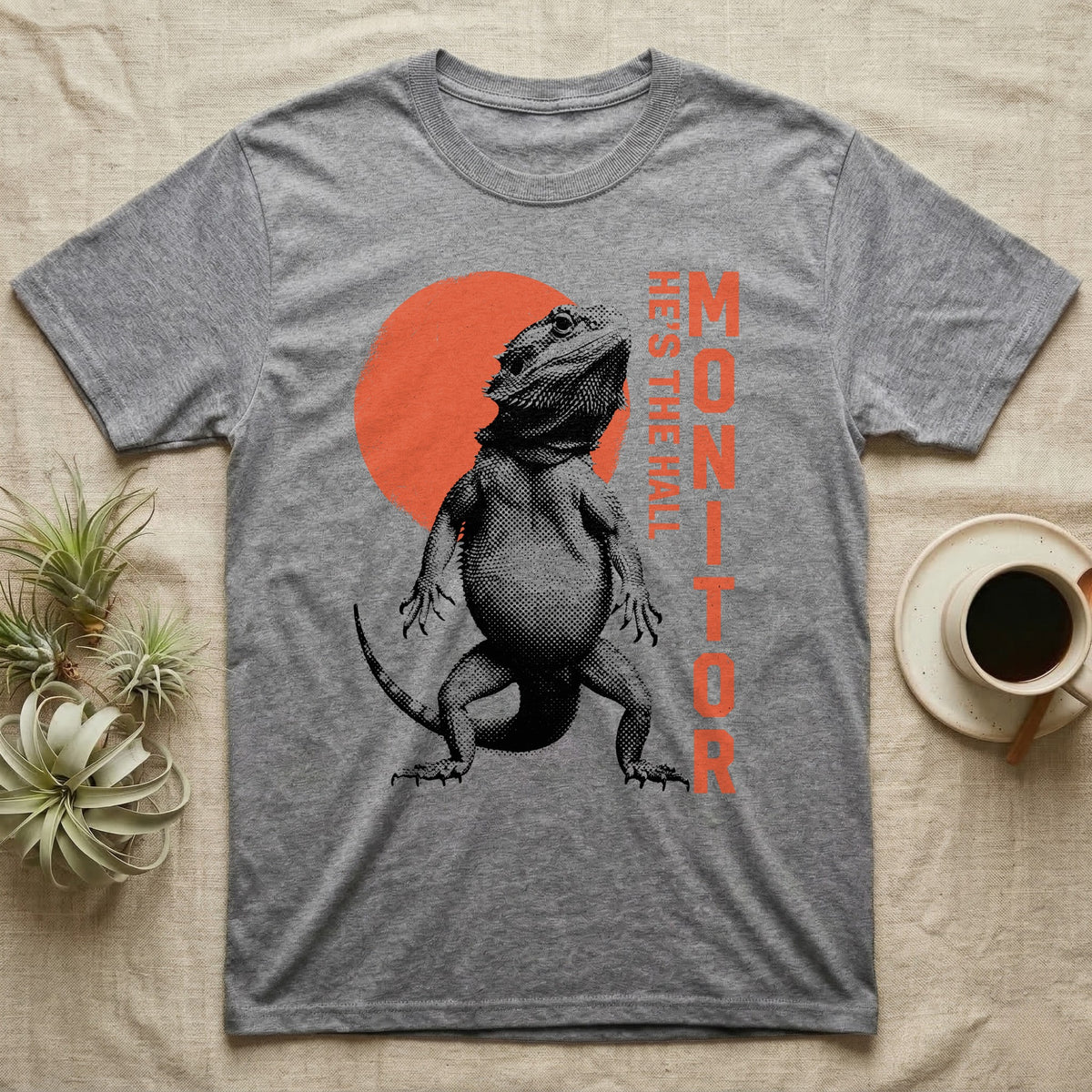 Bearded Dragon Hall Monitor T-Shirt in Sport Grey — Coarse halftone illustration of a bearded dragon mid-stride, a distressed vermilion disc behind and HALL MONITOR alongside.