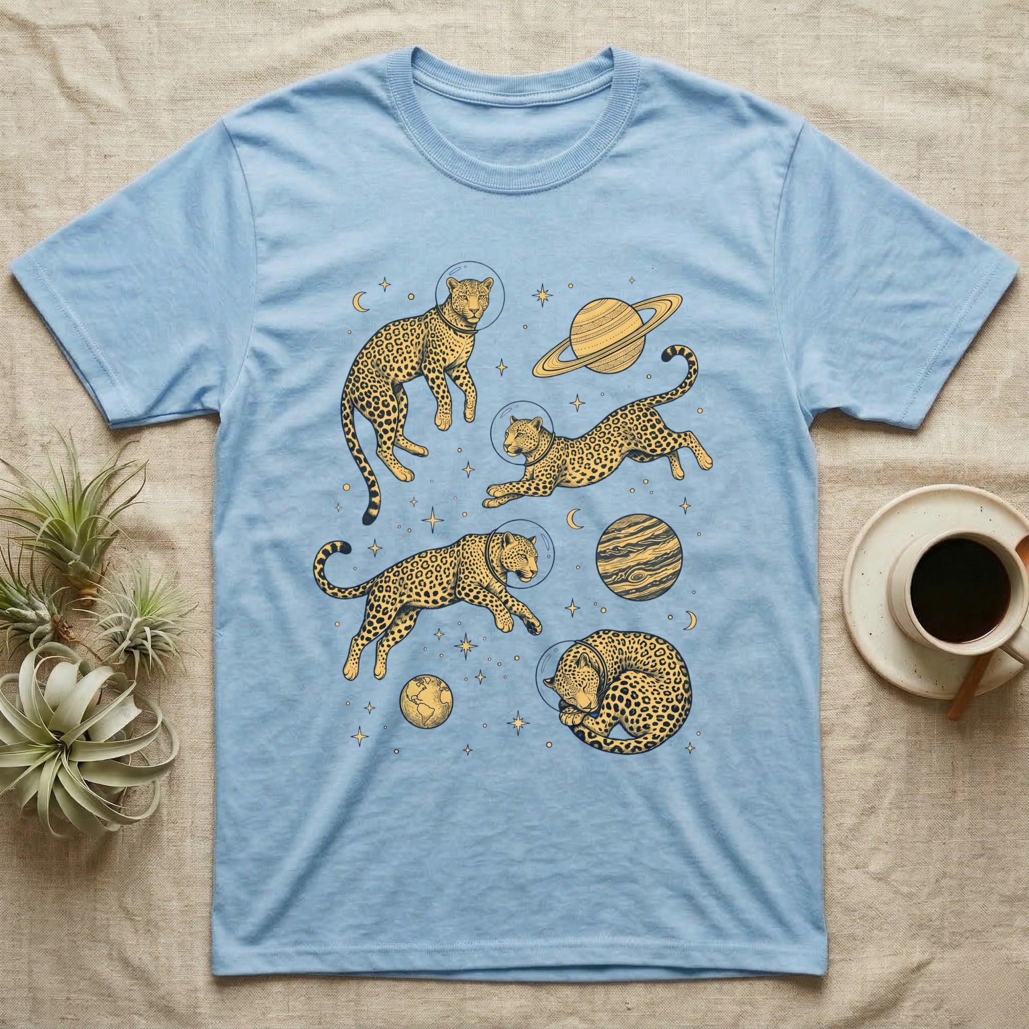 Blue t-shirt with leopards in space wearing astronaut helmets and planets.