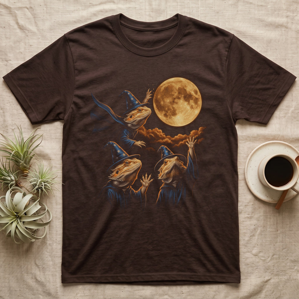 Bearded Dragon Wizard T-Shirt in Dark Chocolate — Three bearded dragons in blue wizard hats and robes under a glowing amber full moon, one casting sparks, two waving up
