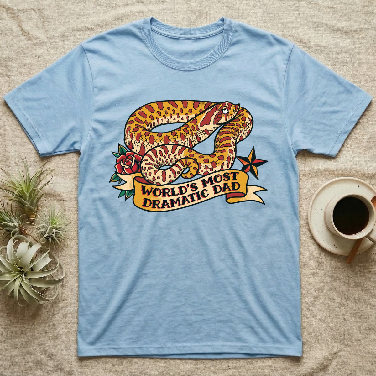 Dramatic Dad Hognose T-Shirt in Light Blue — Tattoo-flash illustration of a hognose snake mid-dramatic-flop with a banner reading World's Most Dramatic Dad.