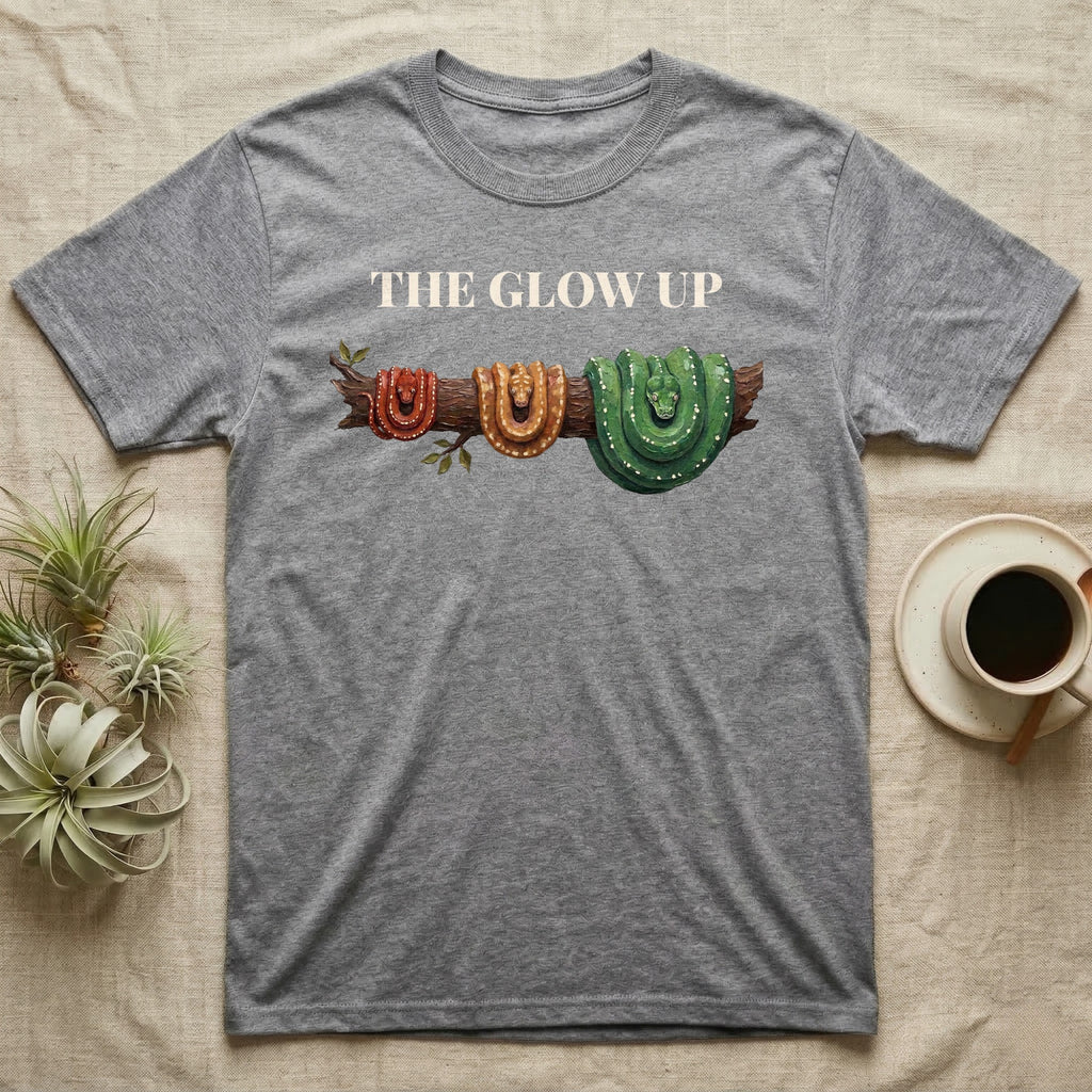 Green Tree Python Glow-Up T-Shirt in Sport Grey — Impasto illustration of a green tree python at three life stages on one branch: red hatchling, orange-brown subadult, green adult.