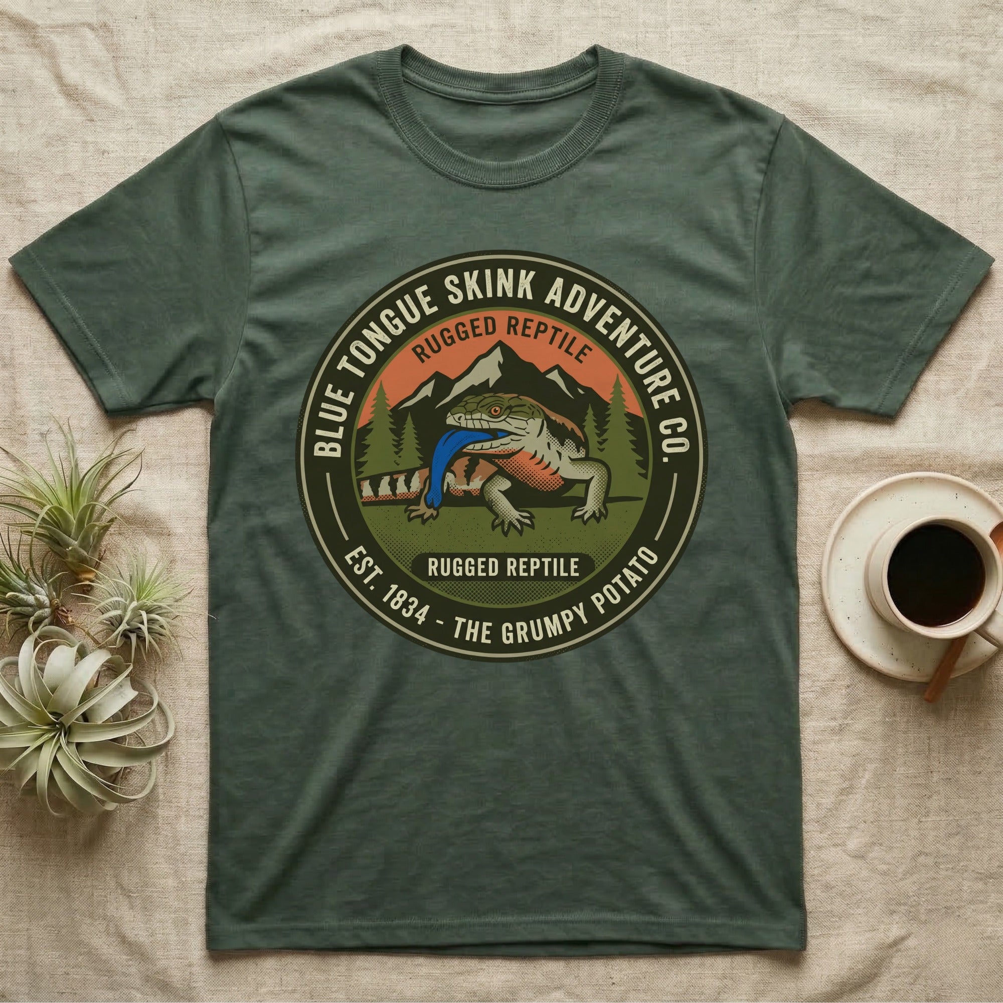Green t-shirt with Blue Tongue Skink Adventure Co. logo featuring a lizard.