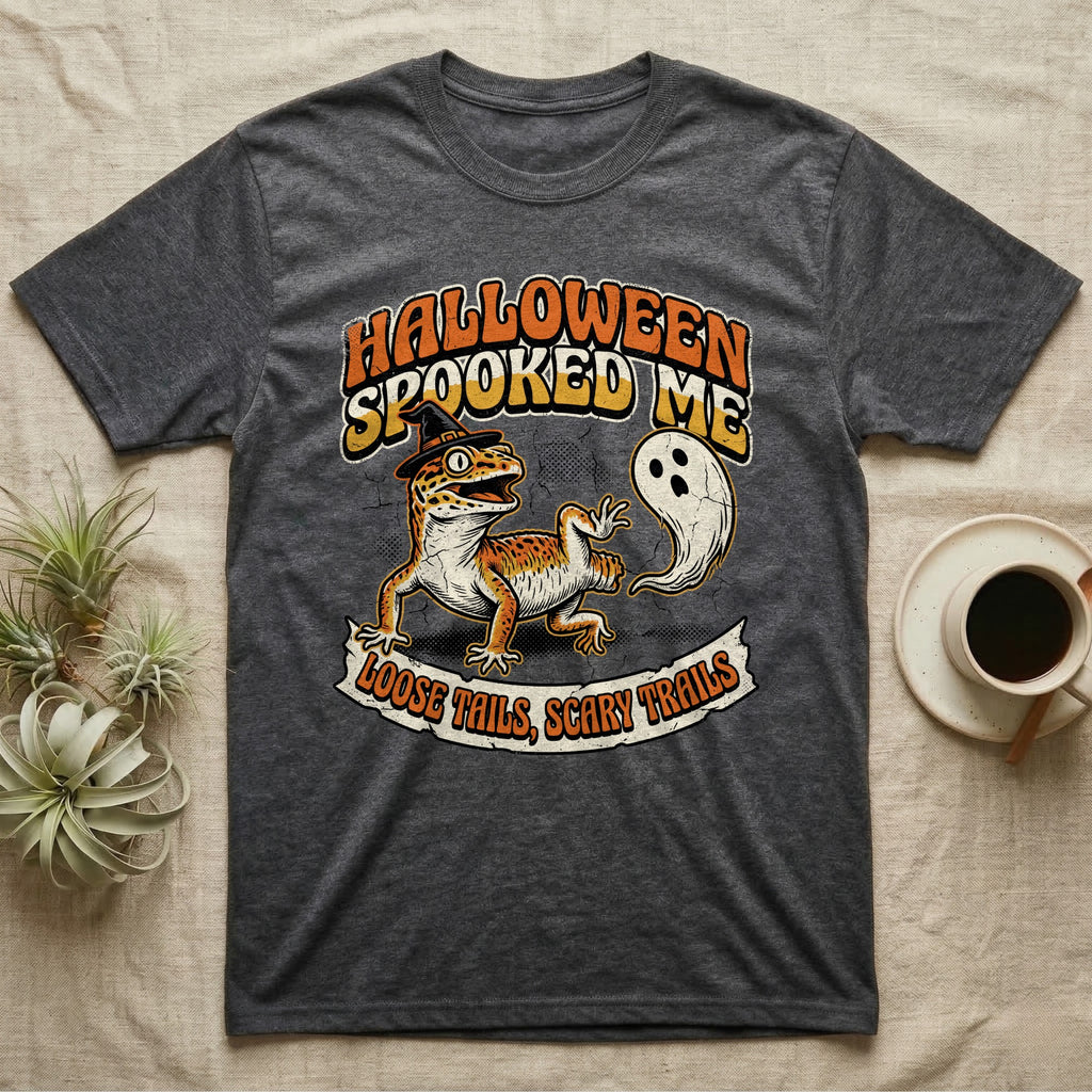 Leopard Gecko Spooked Me T-Shirt in Dark Heather — Distressed graphic of a shocked leopard gecko in a witch hat beside its ghost-costumed dropped tail, "Halloween Spooked Me."