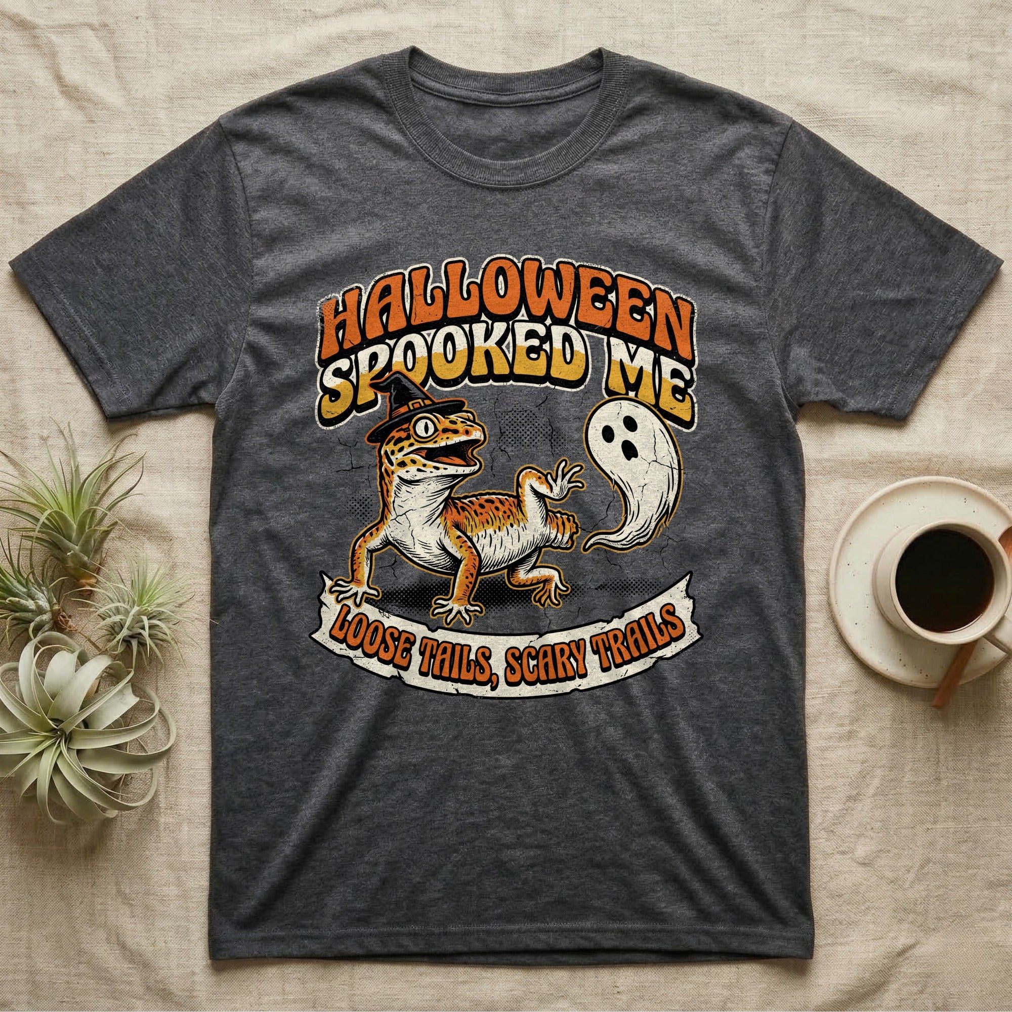 Leopard Gecko Spooked Me T-Shirt in Dark Heather — Distressed graphic of a shocked leopard gecko in a witch hat beside its ghost-costumed dropped tail, "Halloween Spooked Me."