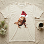 Vintage comic illustration of a bearded dragon wearing a red and white Santa hat, graphic-only, no text. — shown on a Natural tee.