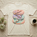 Stacked pastel snakes illustration on a cream t-shirt.