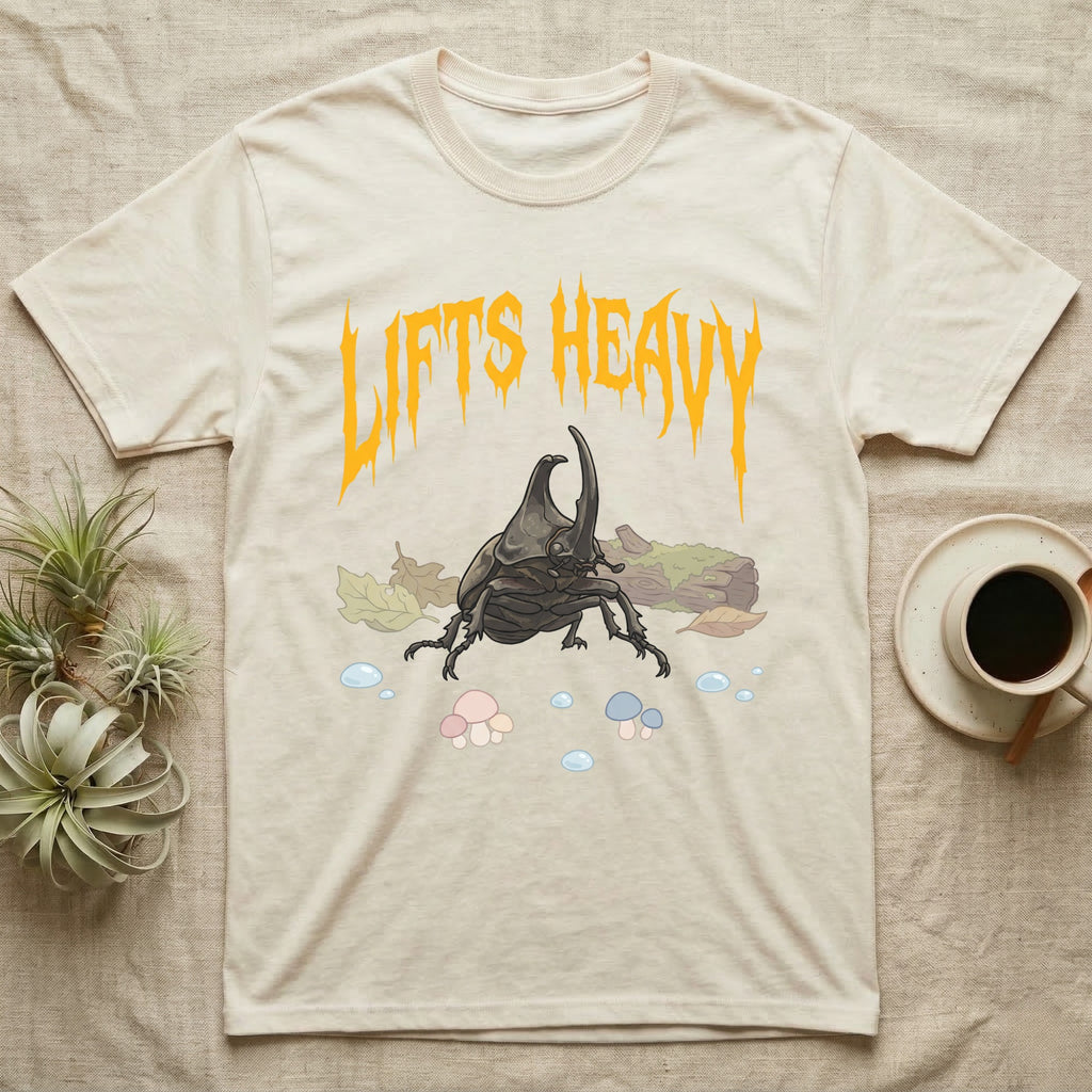 Rhino Beetle Feral T-Shirt in Natural — Horned rhinoceros beetle standing head-on below a dripping amber-gold metal "Lifts Heavy" wordmark