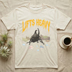 Rhino Beetle Feral T-Shirt in Natural — Horned rhinoceros beetle standing head-on below a dripping amber-gold metal "Lifts Heavy" wordmark