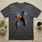 Dark gray t-shirt with a toucan perched on a branch with purple wisteria.
