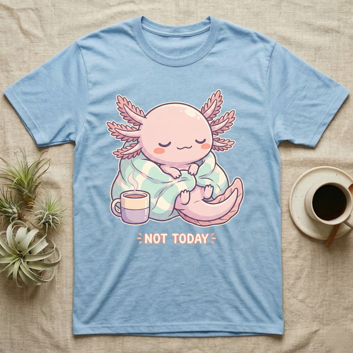Axolotl Not Today T-Shirt in Light Blue — Kawaii chibi illustration of an axolotl curled in a blanket with a mug and a soft caption reading Not Today.