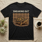 Box Turtle Sneaking T-Shirt in Black — Eastern box turtle crawling out from under a brown picket fence beneath the words Sneaking Out