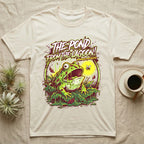 Pacman Frog Lagoon Apocalypse T-Shirt in Natural — B-movie horror poster of a Pacman frog bursting from slime at a fly, "The Pond From the Lagoon, Amphibian Apocalypse."