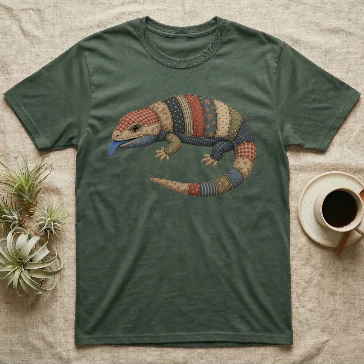 T-shirt with a patchwork lizard graphic.