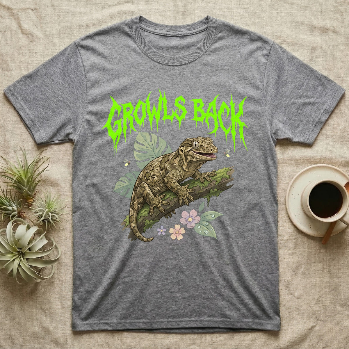 Leachianus Gecko Feral T-Shirt in Sport Grey — Leachianus giant gecko on a mossy branch under jagged lime-green metal text GROWLS BACK with pastel leaves