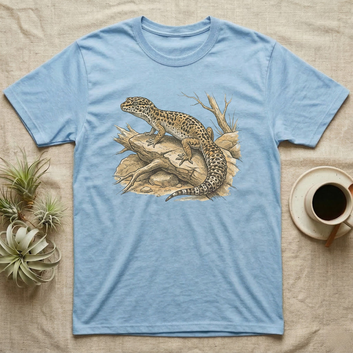Light blue t-shirt with a detailed illustration of a leopard gecko on a branch.