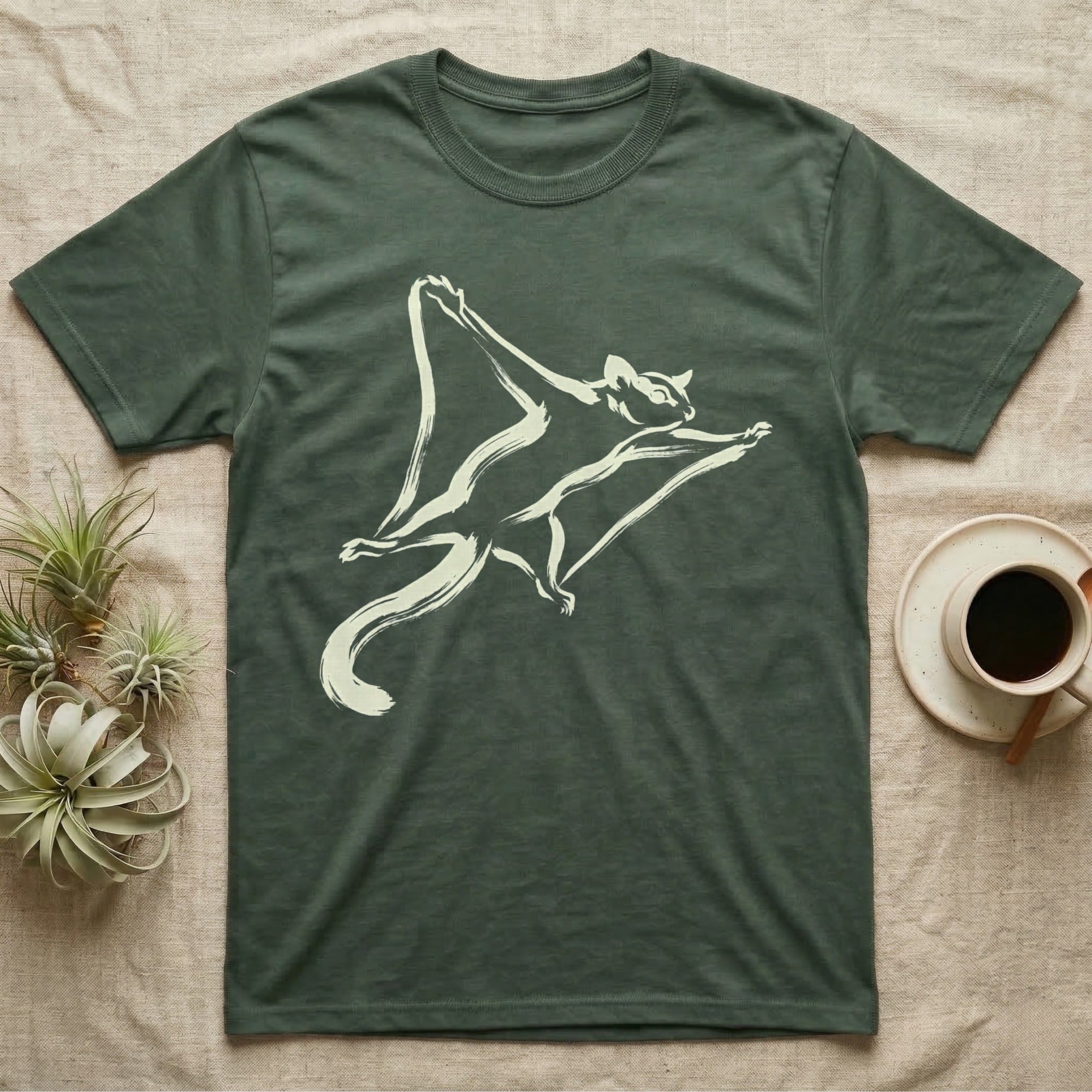 Dark green t-shirt with cream flying squirrel graphic and coffee cup.