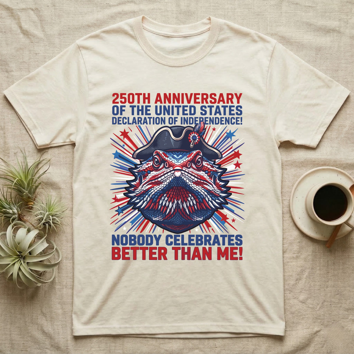 Bearded Dragon Fireworks T-Shirt in Natural — Pop-art bearded dragon head in a tricorn hat amid red-white-blue fireworks under Nobody Celebrates Better Than Me.