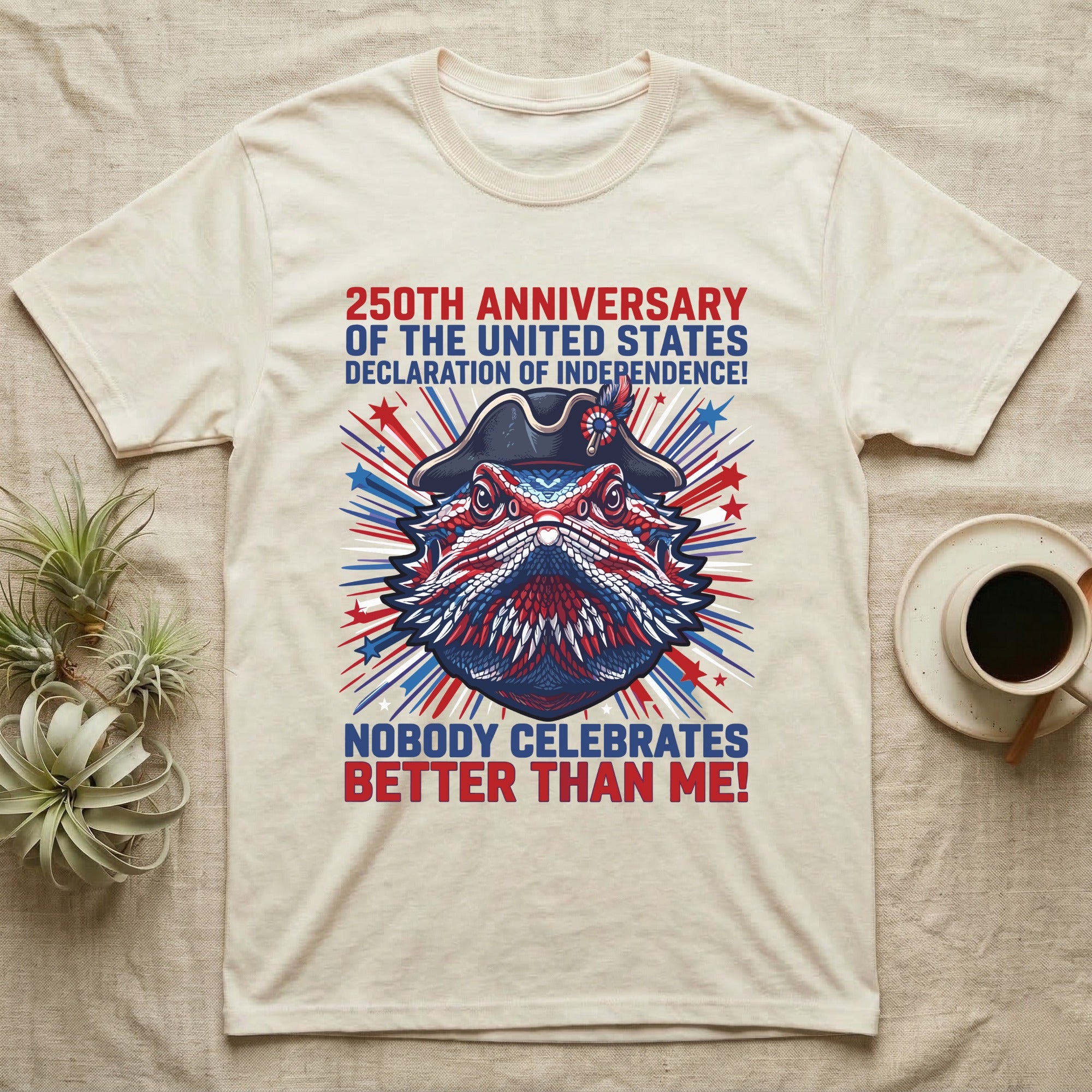 Bearded Dragon Fireworks T-Shirt in Natural — Pop-art bearded dragon head in a tricorn hat amid red-white-blue fireworks under Nobody Celebrates Better Than Me.