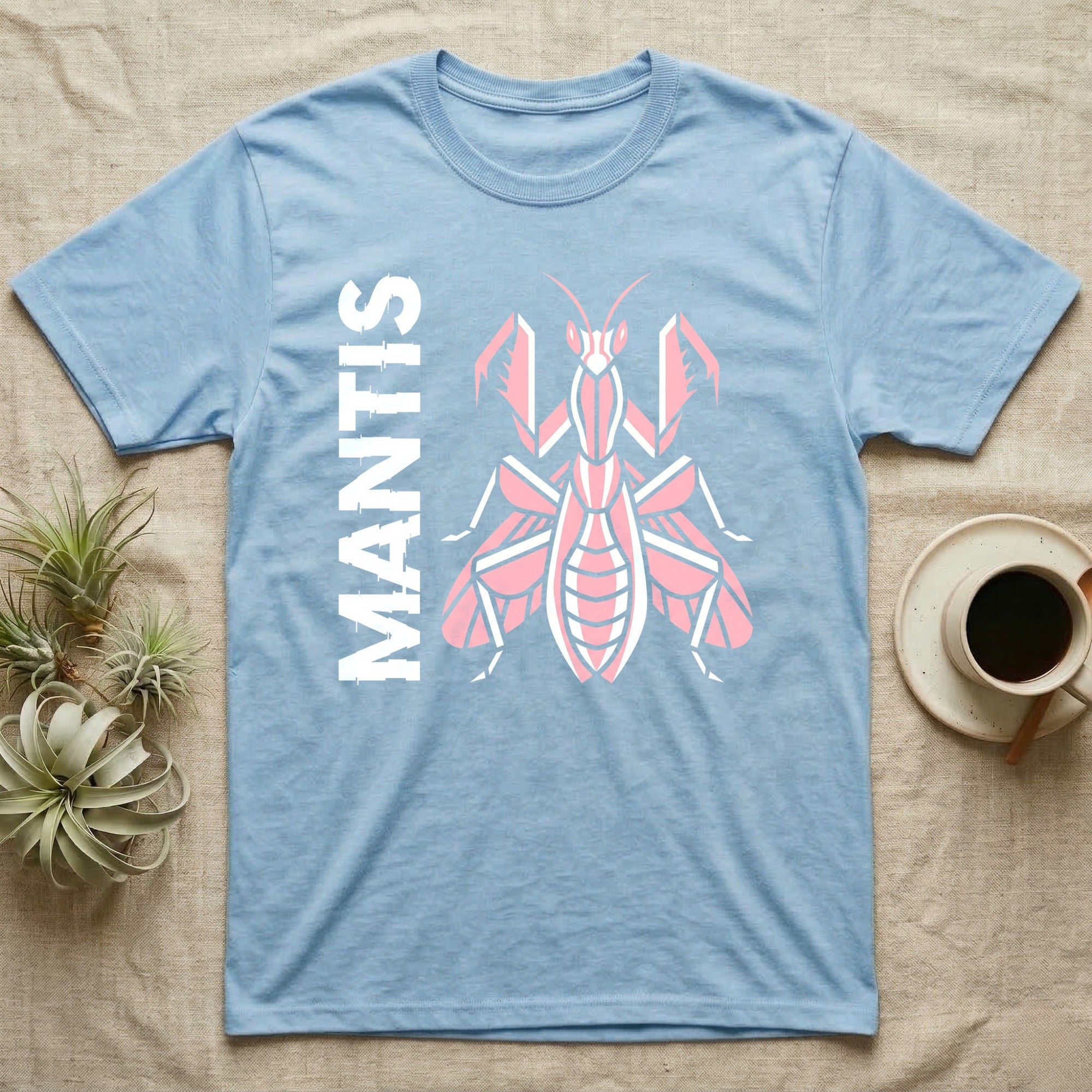 Light blue t-shirt with a pink and white mantis graphic and "MANTIS" text.
