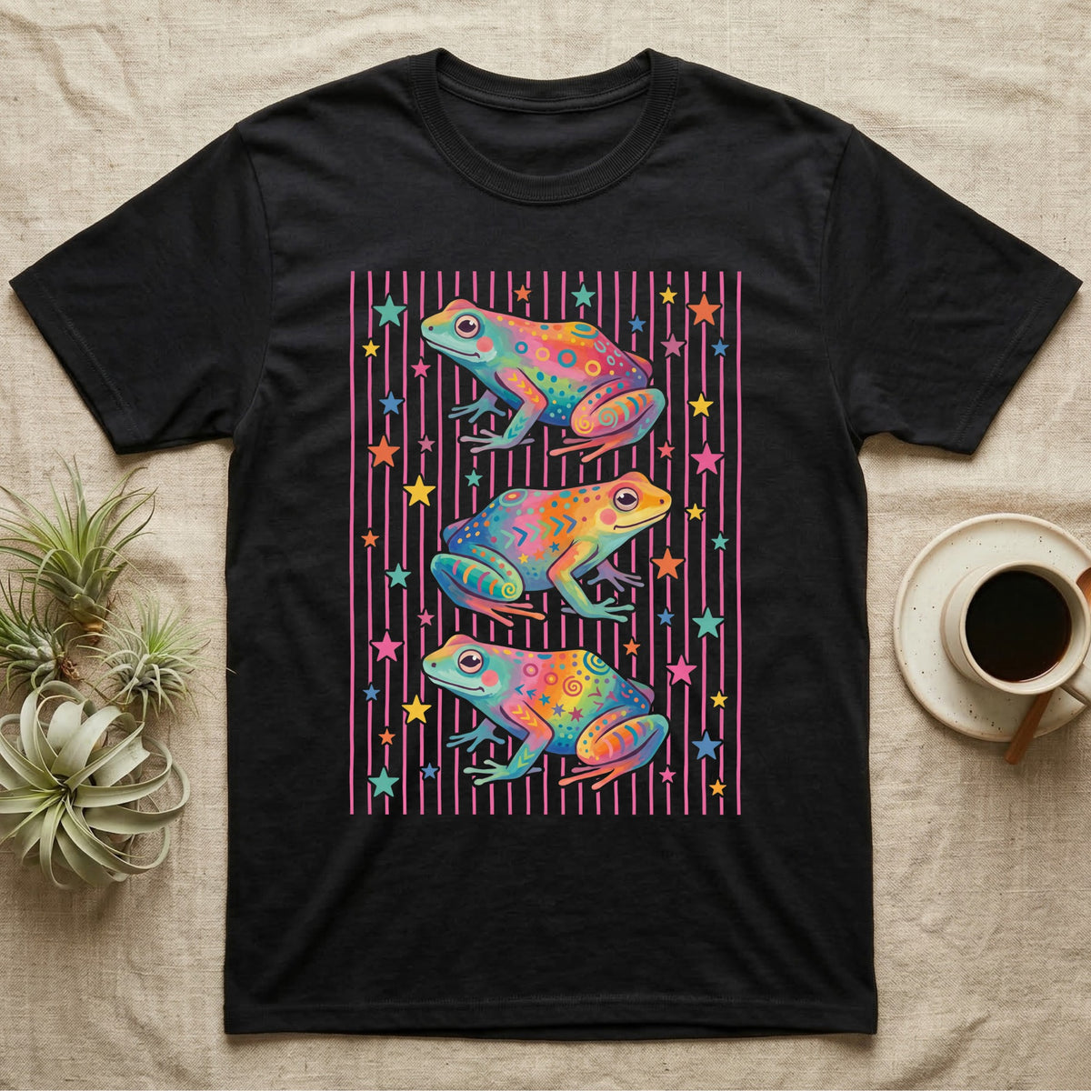 Dart Frog Disco Stripes T-Shirt in Black — Three rainbow poison dart frog morphs stacked on a pink-and-cream candy-stripe field with scattered stars.