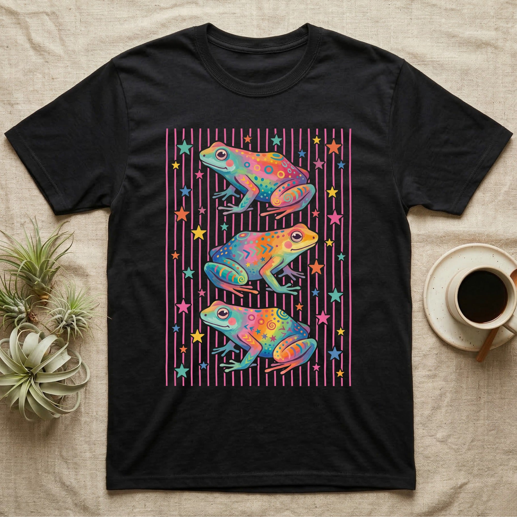 Dart Frog Disco Stripes T-Shirt in Black — Three rainbow poison dart frog morphs stacked on a pink-and-cream candy-stripe field with scattered stars.