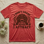 Alligator Snapper Lure T-Shirt in Heather Red — Folk-print alligator snapping turtle, jaws open, tongue lure out, a fish swimming in, text I Don't Chase I Attract