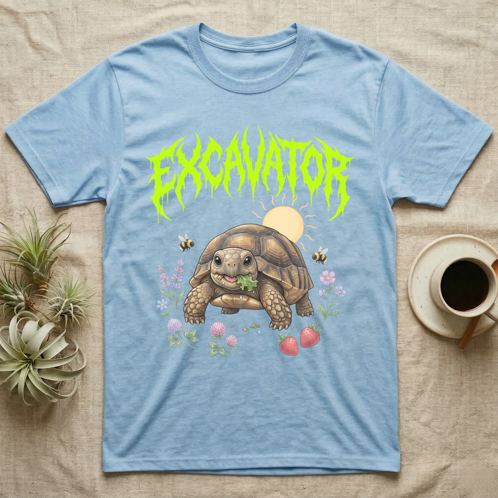 Russian Tortoise Feral T-Shirt in Light Blue — Chubby Russian tortoise munching a green in a pastel meadow under a spiky lime metal wordmark reading EXCAVATOR.