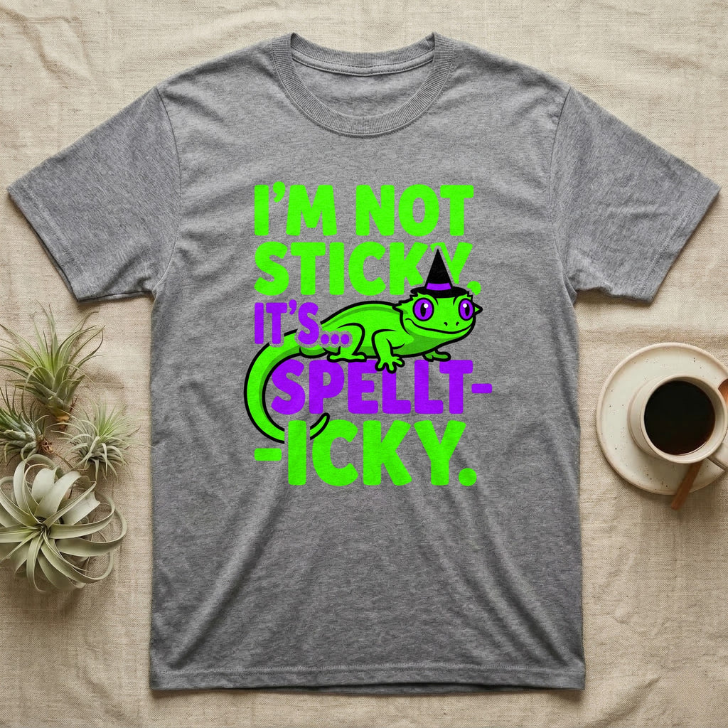 Crested Gecko Spellt-icky T-Shirt in Sport Grey — Neon cartoon crested gecko in a witch hat with stacked text, "I'm Not Sticky, It's Spellt-icky."