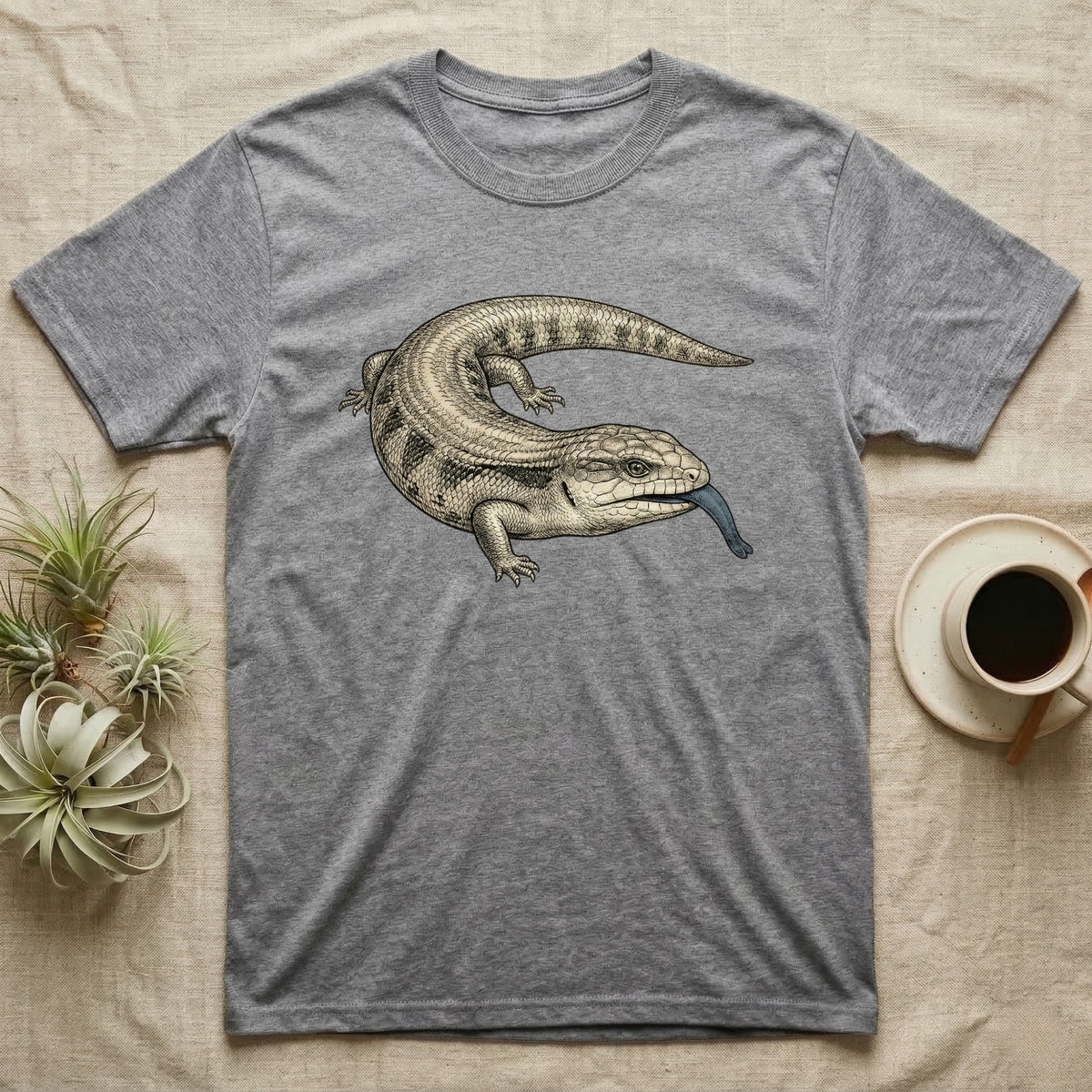Grey t-shirt with a blue-tongued skink illustration.