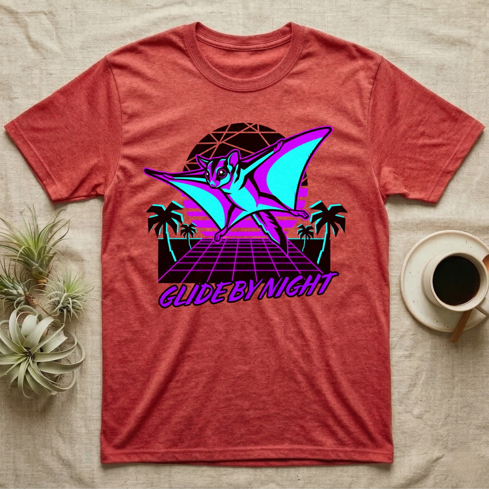 Gliding sugar glider with retro sunset and palm trees graphic on red t-shirt.