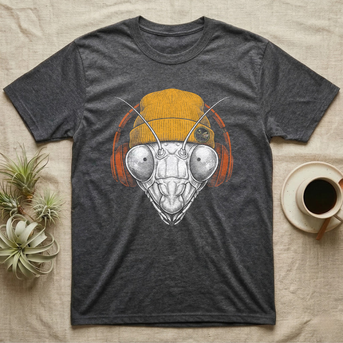 Praying Mantis Chill Beats T-Shirt in Dark Heather — Engraved praying mantis with large compound eyes and antennae, wearing a knit beanie and over-ear headphones.