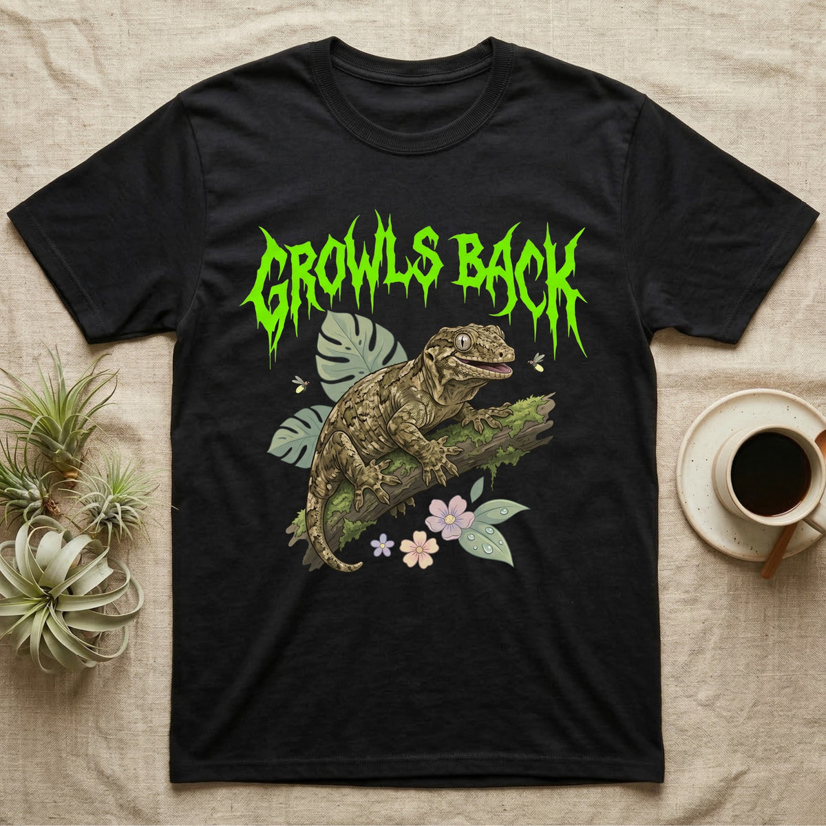Leachianus Gecko Feral T-Shirt in Black — Leachianus giant gecko on a mossy branch under jagged lime-green metal text GROWLS BACK with pastel leaves