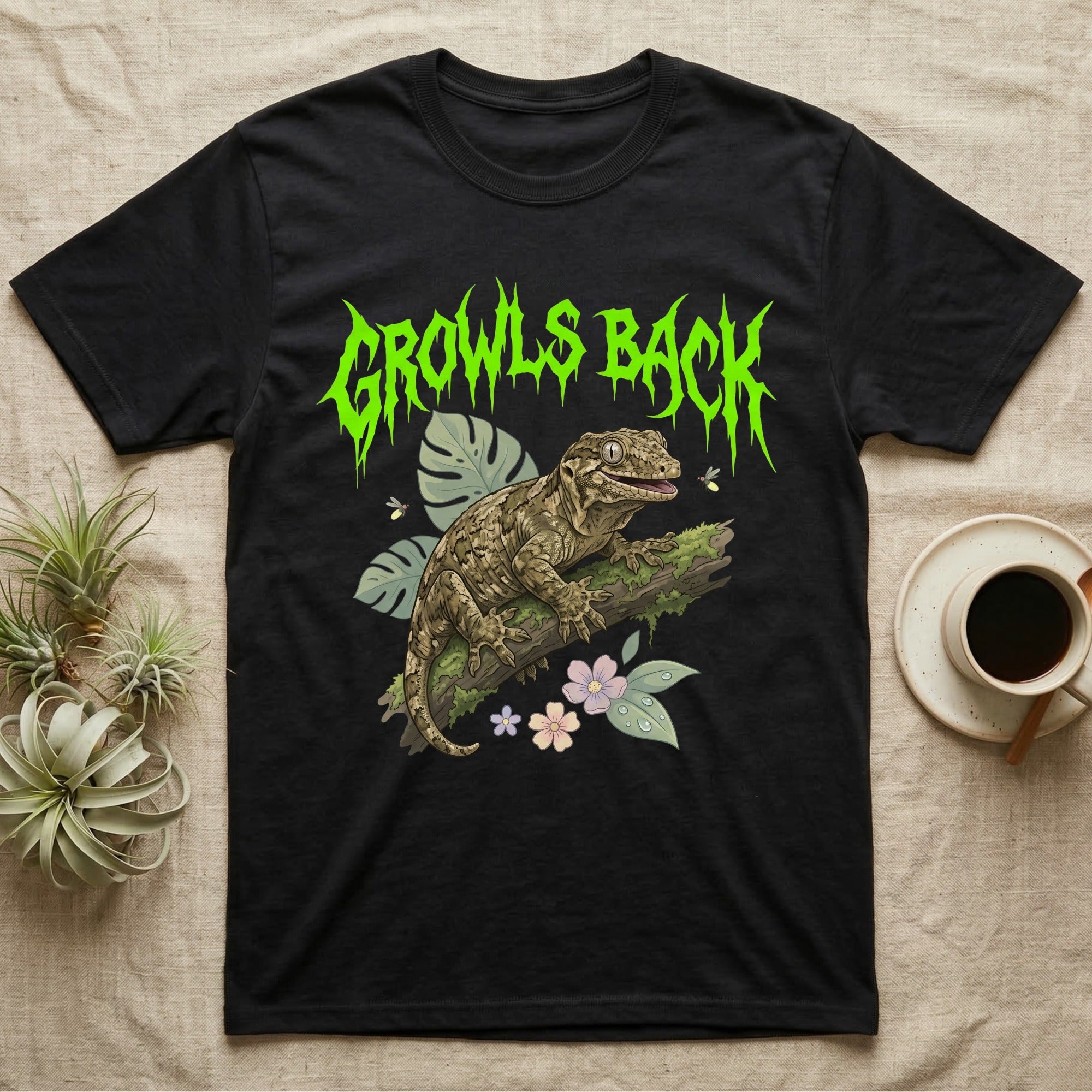 Leachianus Gecko Feral T-Shirt in Black — Leachianus giant gecko on a mossy branch under jagged lime-green metal text GROWLS BACK with pastel leaves