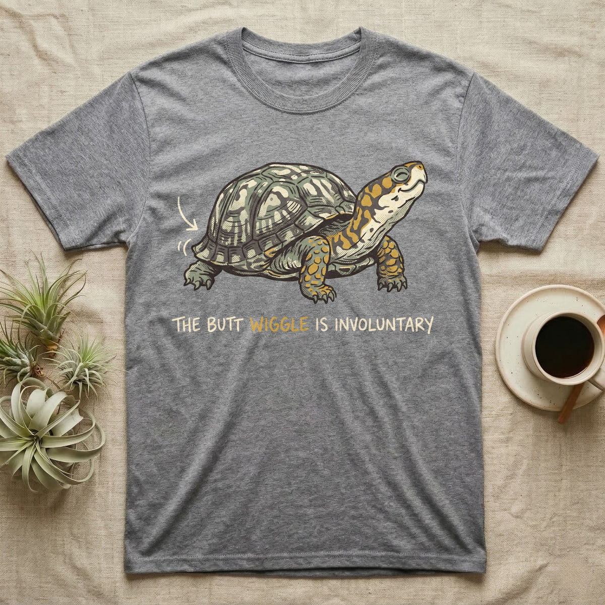 Box Turtle Wiggle T-Shirt in Sport Grey — Retro-illustration of a box turtle mid shell-scratch with a hand-drawn arrow at its wiggling rear and a deadpan marker caption.