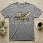 Box Turtle Wiggle T-Shirt in Sport Grey — Retro-illustration of a box turtle mid shell-scratch with a hand-drawn arrow at its wiggling rear and a deadpan marker caption.
