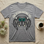 Phidippus Regius Jumping Spider Tee in Sport Grey — Vector-bold front-facing regal jumping spider portrait with electric-teal anterior-median eyes on a cream-and-charcoal body.