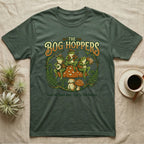 Green t-shirt with illustration of frogs playing instruments on a mushroom.