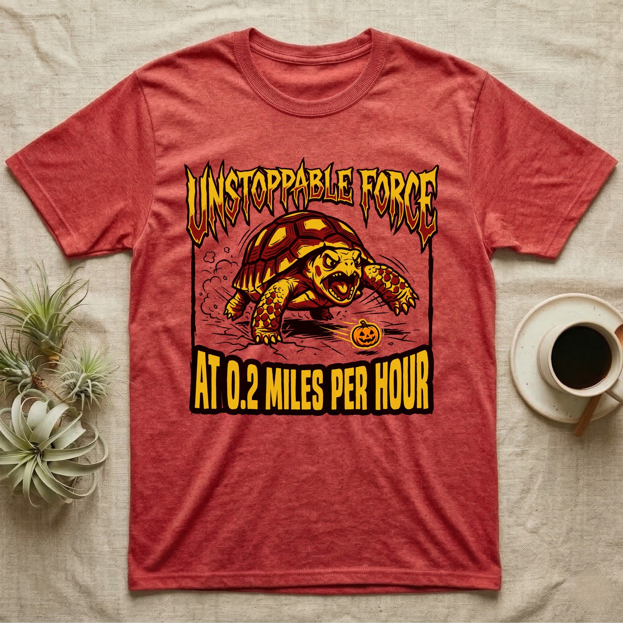 Red-Footed Tortoise Unstoppable Force T-Shirt in Heather Red — Metal-style furious tortoise charging a candy pumpkin, "Unstoppable Force At 0.2 Miles Per Hour."
