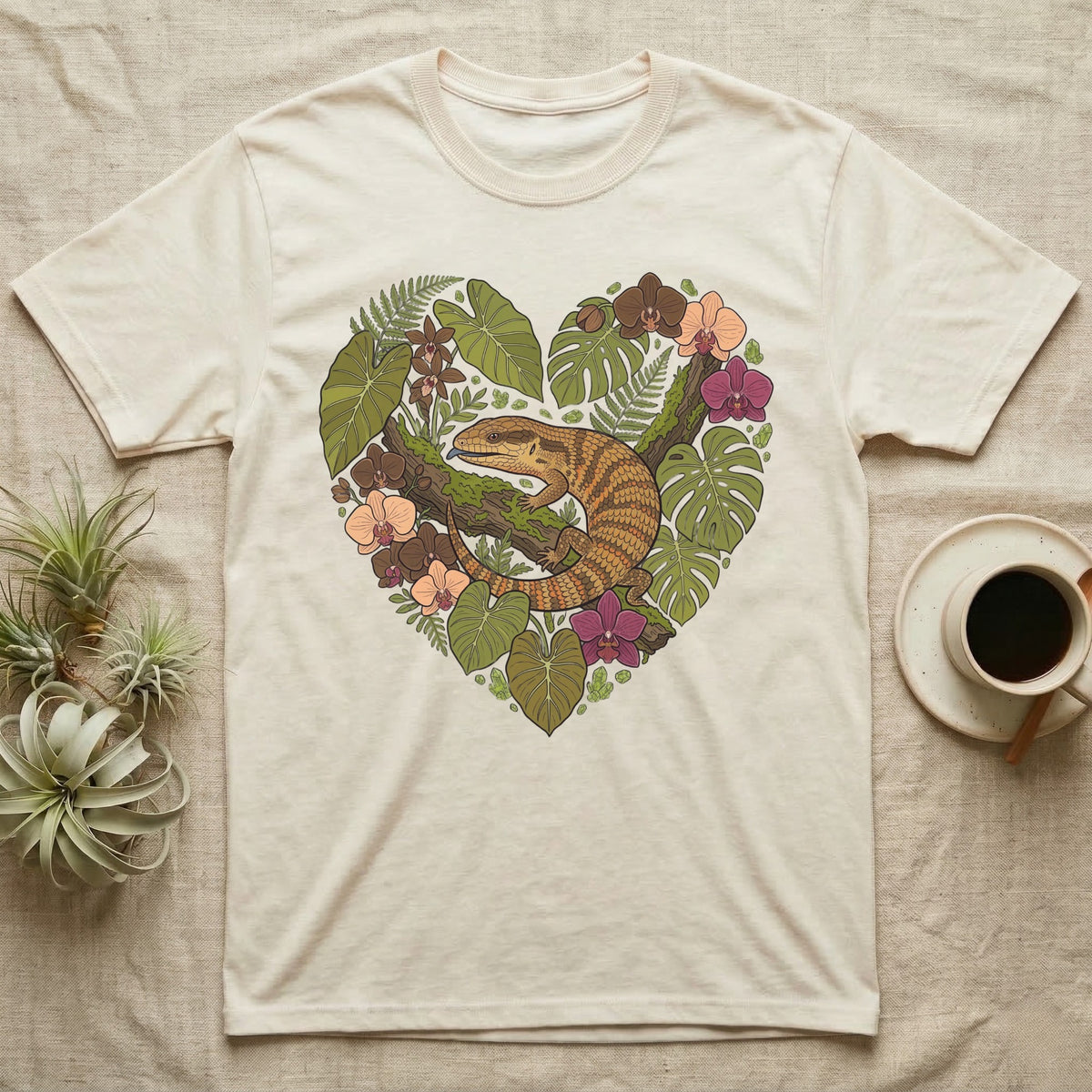 Cream t-shirt with a heart-shaped botanical illustration featuring a lizard.