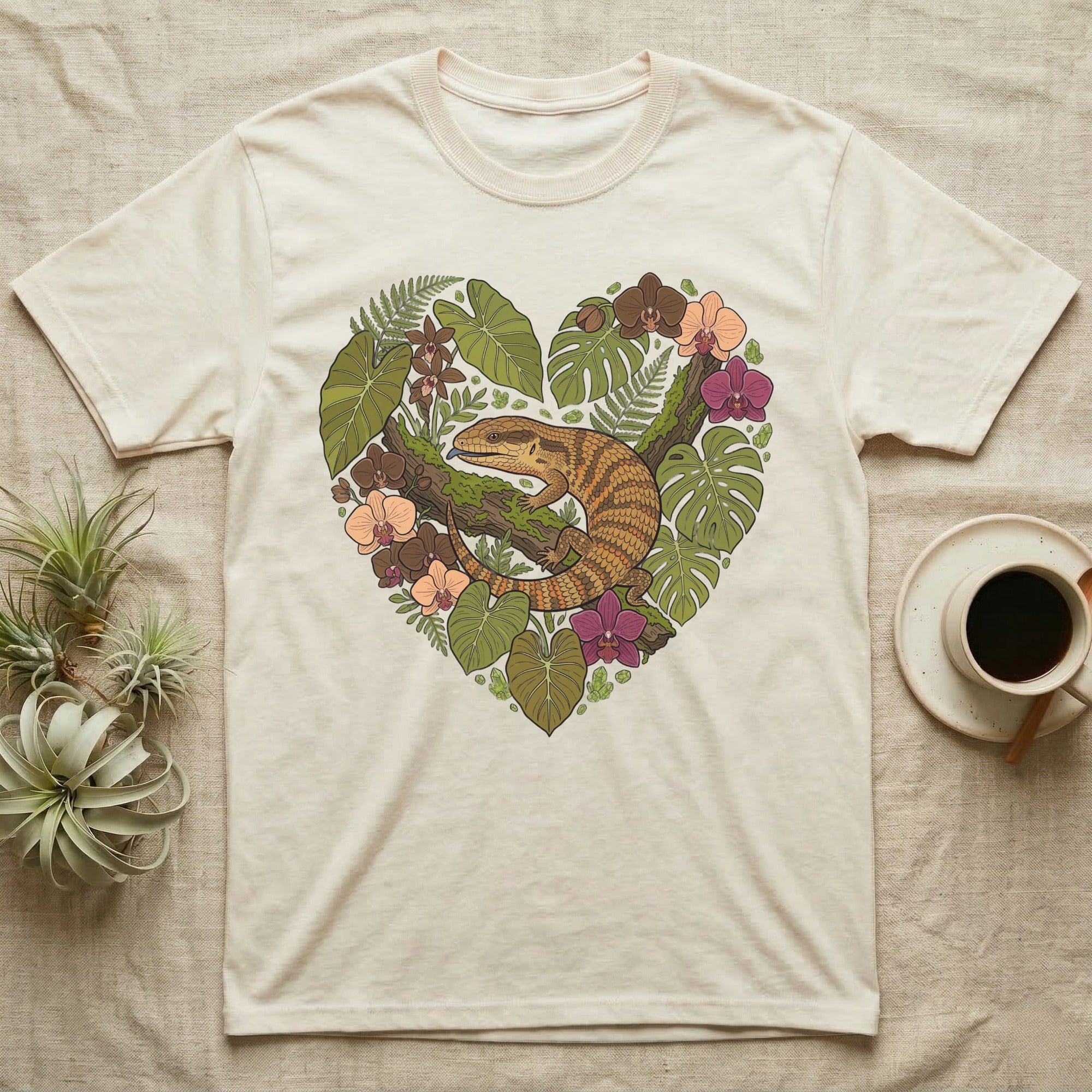 Cream t-shirt with a heart-shaped botanical illustration featuring a lizard.