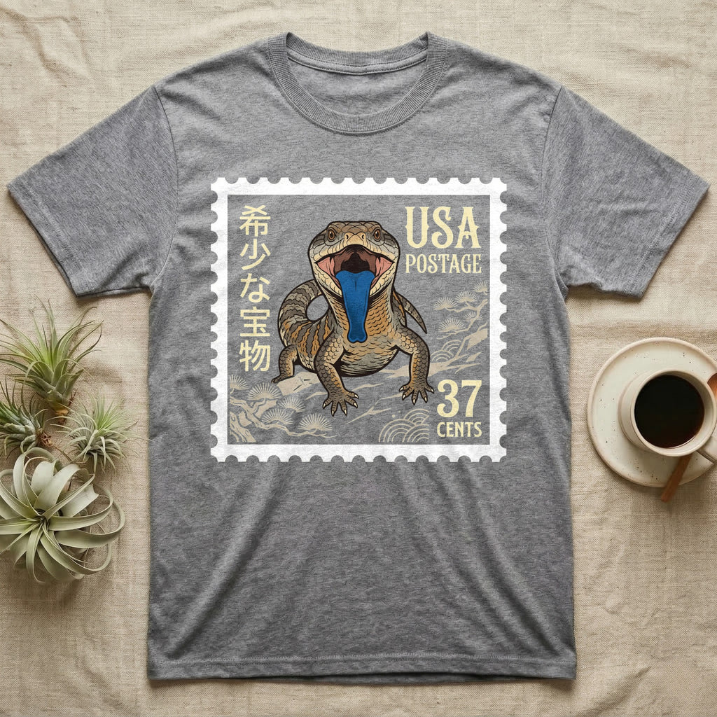 Grey t-shirt with a stamp featuring a lizard with blue tongue and "USA Postage 37 Cents".