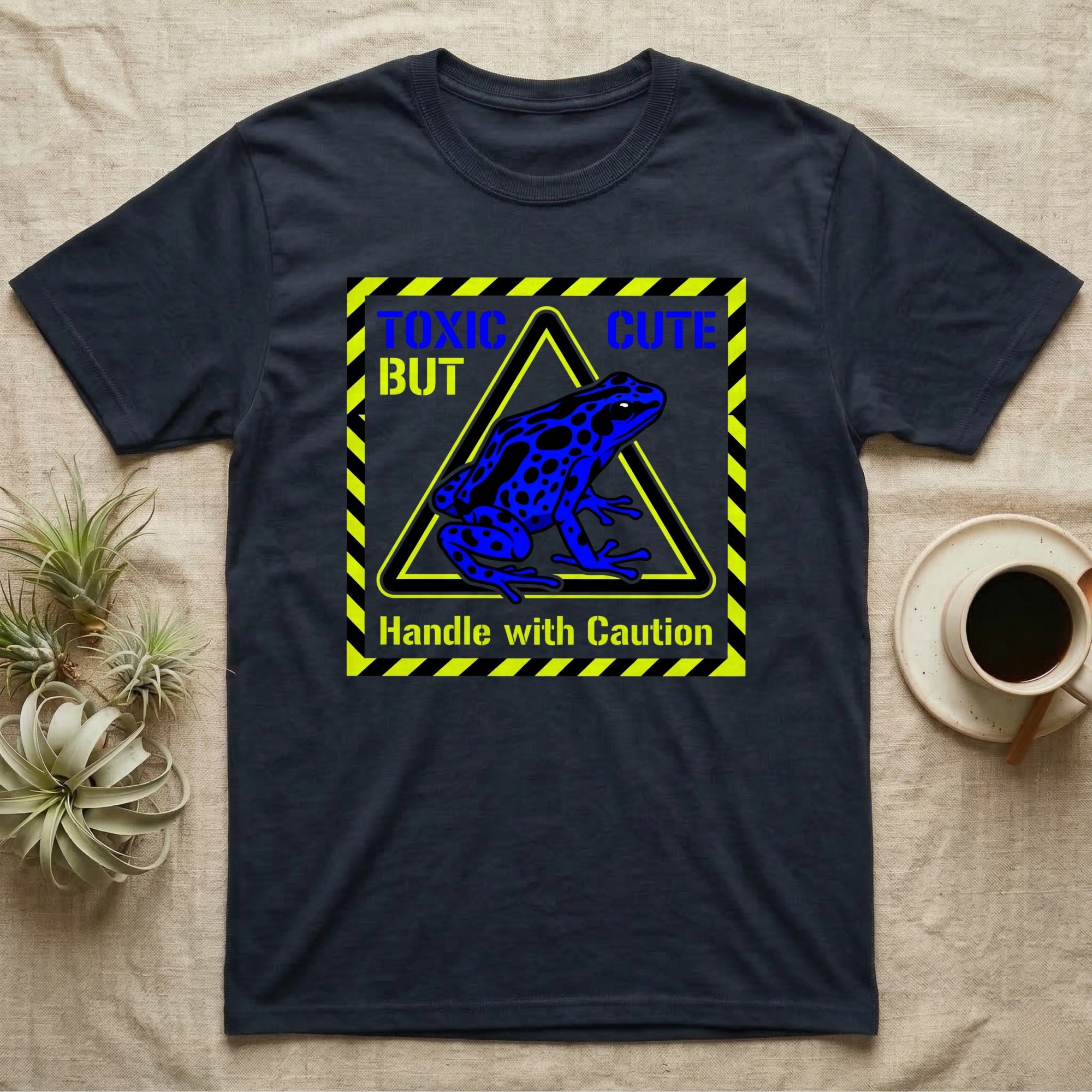 Dark blue t-shirt with "TOXIC BUT CUTE" and a blue poison dart frog.