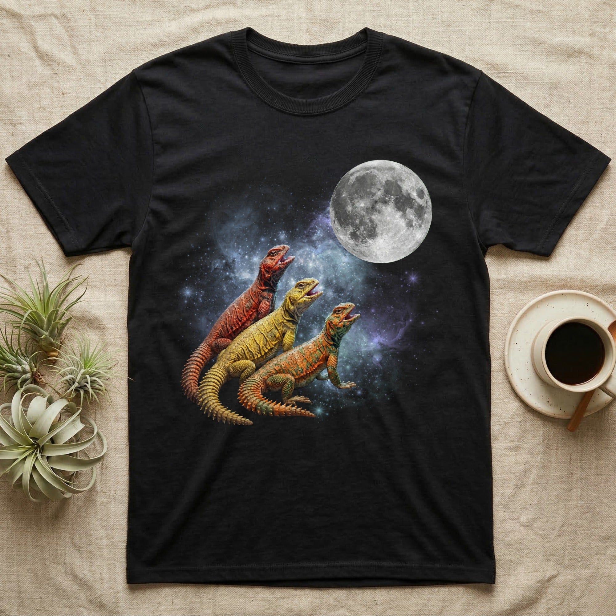 Uromastyx Moon Howl T-Shirt in Black — Three Uromastyx colour morphs howling at a full moon over a nebula on a dark grey t-shirt.