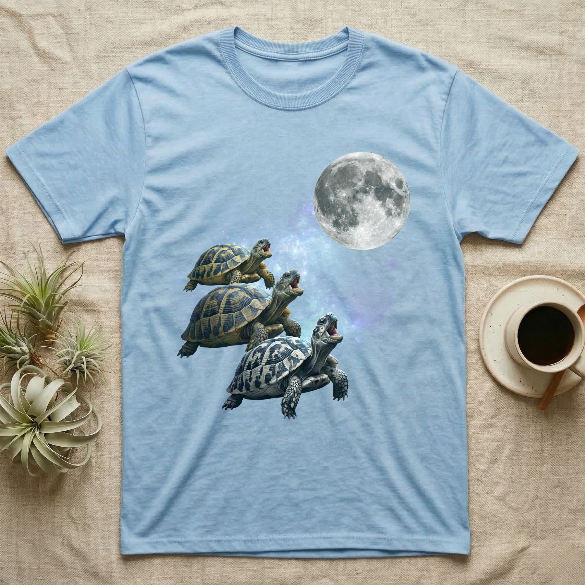 Hermann's Tortoise Moon Howl T-Shirt in Light Blue — Three Hermann's Tortoise colour morphs howling at a full moon over a nebula on a dark grey t-shirt.