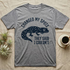 Leopard Gecko Spots T-Shirt in Sport Grey — Navy silhouette of a spotted leopard gecko walking under arched words Changed My Spots, beside They Said I Couldn't