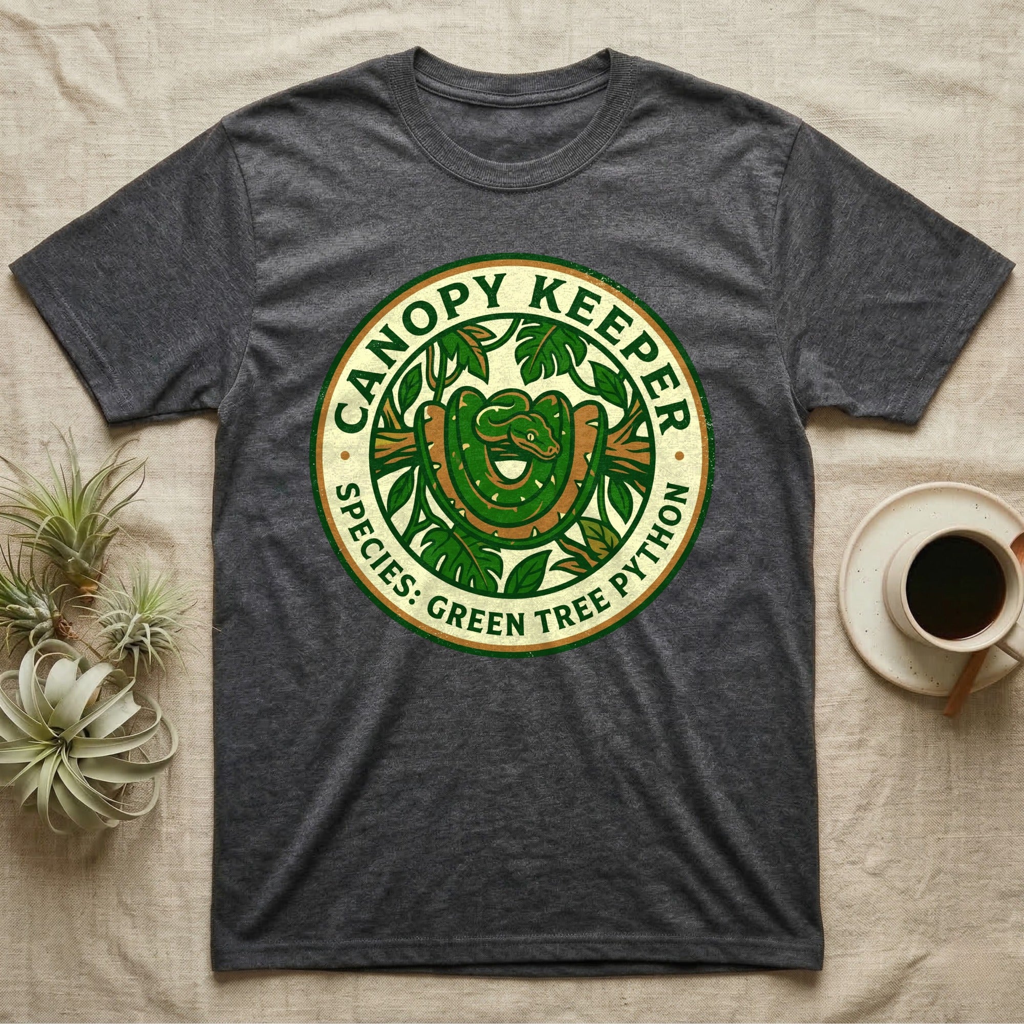 Dark gray t-shirt with a circular logo featuring a green tree python coiled around a branch.